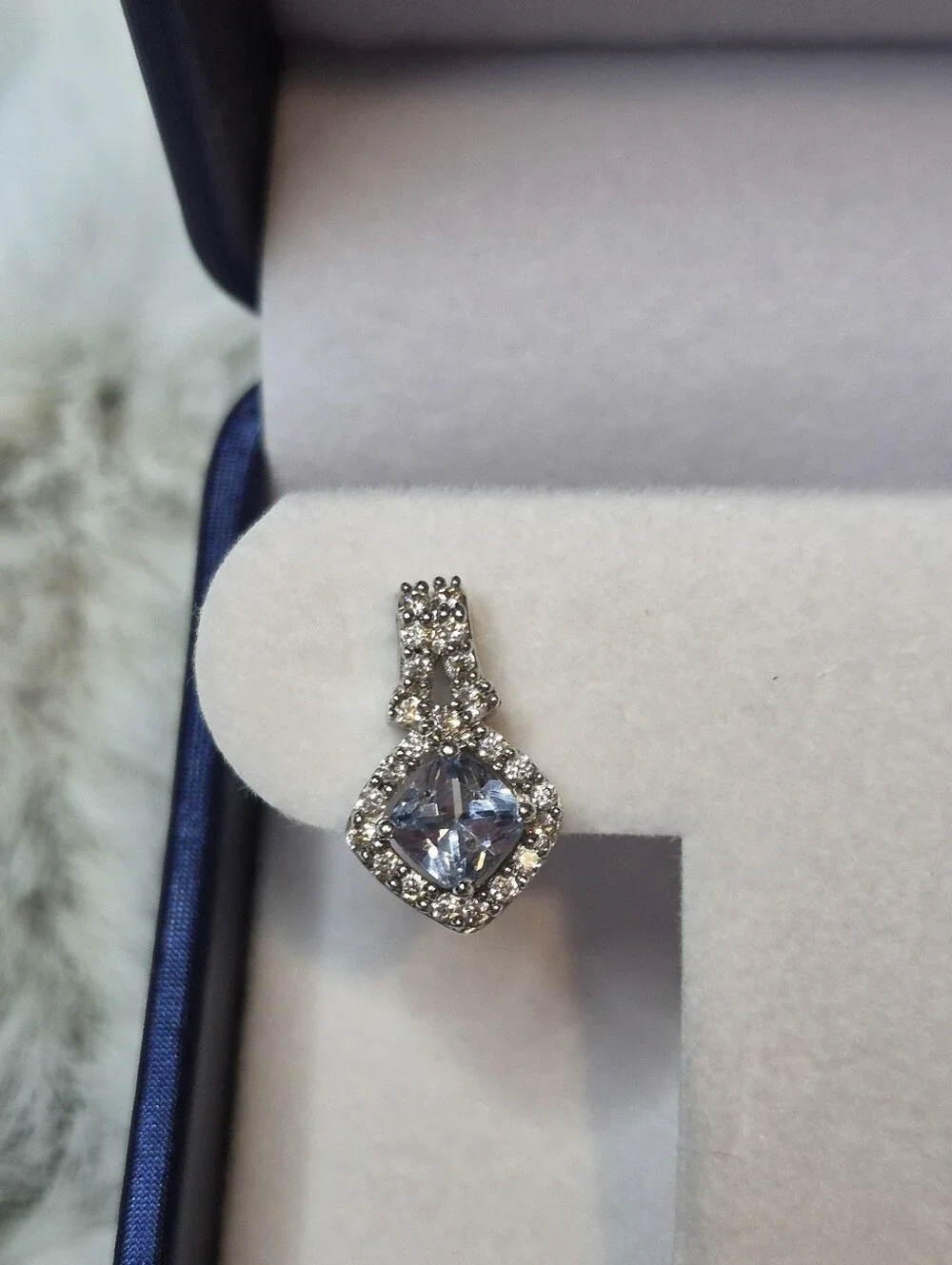 Brighton drop earrings feature a striking cushion-cut blue crystal center